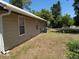 Exterior view showing a well maintained lawn and the side of the home with the lawn at 677 Warner St, Groveland, FL 34736