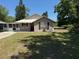 Charming home with a well-manicured front lawn and covered porch, creating a welcoming curb appeal at 677 Warner St, Groveland, FL 34736