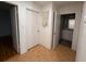 Hallway with open doors leads to bath with vanity sink and additional rooms at 677 Warner St, Groveland, FL 34736