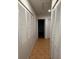 Hallway features ample storage with louvered closet doors and tile flooring at 677 Warner St, Groveland, FL 34736
