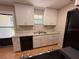 Bright kitchen featuring white cabinets, granite counters, and stainless steel appliances at 677 Warner St, Groveland, FL 34736