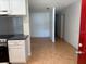 Open floor plan with modern kitchen leading into living area with tiled floor at 677 Warner St, Groveland, FL 34736