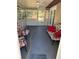 Enclosed sunroom featuring tile flooring, ceiling fan, and exterior views, providing a relaxing space at 677 Warner St, Groveland, FL 34736