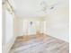Spacious bedroom featuring wood-look floors, bright neutral walls, and ensuite bathroom access at 715 Megan Circle, The Villages, FL 32159