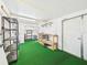 Functional garage space with shelves, workbench, washer, and storage, perfect for projects and organization at 715 Megan Circle, The Villages, FL 32159
