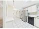 Bright eat-in kitchen features tile floors, stainless steel appliances, and breakfast bar at 715 Megan Circle, The Villages, FL 32159