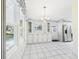 Eat-in kitchen featuring tile floors, classic chandelier, and bright natural light at 715 Megan Circle, The Villages, FL 32159