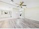 Spacious Living Room with hardwood floors and view into eat-in kitchen area at 715 Megan Circle, The Villages, FL 32159