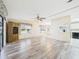 Open-concept living room with hardwood floors, ceiling fan, and plenty of natural light at 715 Megan Circle, The Villages, FL 32159