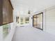 Enclosed sunroom with large windows and sliding glass doors provides ample natural light and outdoor views at 715 Megan Circle, The Villages, FL 32159