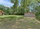 View of the spacious backyard with a storage building, providing ample outdoor space at 7260 Se 124Th Ln, Belleview, FL 34420