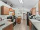 Traditional kitchen with black appliances and wood cabinetry for a cozy, inviting atmosphere at 7260 Se 124Th Ln, Belleview, FL 34420