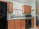 A kitchen with wood cabinets, black appliances, and a window adding to its functional design at 7260 Se 124Th Ln, Belleview, FL 34420