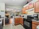The kitchen includes a view to the living room and fireplace, a seamless transition to entertainment space at 7260 Se 124Th Ln, Belleview, FL 34420
