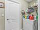Laundry room with white washer and dryer and storage shelves above at 7260 Se 124Th Ln, Belleview, FL 34420