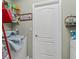 Laundry room with white appliances, shelving, and white door at 7260 Se 124Th Ln, Belleview, FL 34420