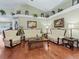 Elegant living room showcasing hardwood floors, ornate furniture, and decorative wall art at 7260 Se 124Th Ln, Belleview, FL 34420