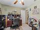 Home office featuring a large desk, ceiling fan, and a door leading to another room at 7260 Se 124Th Ln, Belleview, FL 34420