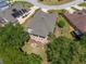 Aerial view of the property featuring a screened-in patio and well-manicured backyard with landscaping at 760 Hammond Pl, The Villages, FL 32162