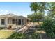 Exterior view of the house with a beautiful yard, featuring well-maintained landscaping at 760 Hammond Pl, The Villages, FL 32162