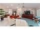 Spacious living room featuring vaulted ceilings, tile floors, comfortable seating, and dining area at 760 Hammond Pl, The Villages, FL 32162