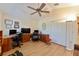 Spacious and bright living room with hardwood floors, ceiling fan, closet, and two work stations at 760 Hammond Pl, The Villages, FL 32162