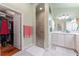 Bright main bathroom with shower and walk-in closet access at 760 Hammond Pl, The Villages, FL 32162