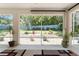 View from the screened porch showcasing the garden with a colorful arrangement and blue fencing at 760 Hammond Pl, The Villages, FL 32162
