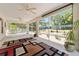 Wide screened porch with a view of the serene backyard featuring a colorful arrangement and garden at 760 Hammond Pl, The Villages, FL 32162