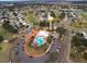 An aerial view showcasing the community pool, clubhouse, parking and golf course of the neighborhood at 819 Hibiscus Dr, The Villages, FL 32159