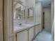 A full bathroom with a double vanity needs updating at 819 Hibiscus Dr, The Villages, FL 32159