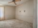 The carpeted bedroom features neutral walls and a ceiling fan at 819 Hibiscus Dr, The Villages, FL 32159