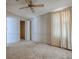 A secondary bedroom features neutral walls and a ceiling fan at 819 Hibiscus Dr, The Villages, FL 32159