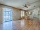 Open dining area with hardwood floors, chandelier, and view to the outside porch through sliding glass door at 819 Hibiscus Dr, The Villages, FL 32159