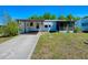Charming single-story home featuring a covered parking area and a cozy screened-in porch at 819 Hibiscus Dr, The Villages, FL 32159