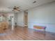 Large living room with hardwood floors, ceiling fan, and view to dining area and bathroom at 819 Hibiscus Dr, The Villages, FL 32159