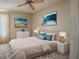 Relaxing bedroom features neutral tones, ambient lighting, and decor at 819 Hibiscus Dr, The Villages, FL 32159