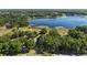 Enjoy this home's stunning lakeside views from above, surrounded by lush greenery and tall trees at 848 Hawk Lndg, Fruitland Park, FL 34731