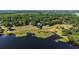 The property's lakeside backyard features ample green space with a grassy lawn and lake access at 848 Hawk Lndg, Fruitland Park, FL 34731
