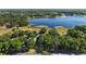Aerial view showing property lines and proximity to a scenic lake surrounded by lush greenery at 848 Hawk Lndg, Fruitland Park, FL 34731
