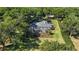 Aerial view of property shows the pool, landscaping, screened in porch, and surrounding trees at 848 Hawk Lndg, Fruitland Park, FL 34731