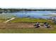 The property's backyard is the perfect spot to relax by the lake with a pier and fire pit at 848 Hawk Lndg, Fruitland Park, FL 34731
