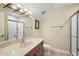 Bathroom featuring a marble countertop, a glass-door shower, and neutral wall color at 848 Hawk Lndg, Fruitland Park, FL 34731