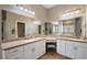 Bright main bathroom vanity area featuring dual sinks, ample counter space, and great mirrors at 848 Hawk Lndg, Fruitland Park, FL 34731