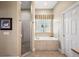 Relaxing bathroom with a separate shower and soaking tub, complemented by natural light at 848 Hawk Lndg, Fruitland Park, FL 34731