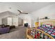 Spacious, carpeted bedroom with a ceiling fan and access to multiple storage spaces at 848 Hawk Lndg, Fruitland Park, FL 34731