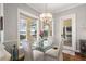 Bright dining area featuring water view, glass table, and stylish chandelier at 848 Hawk Lndg, Fruitland Park, FL 34731