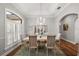 Charming dining room features a chandelier, and views of lush landscaping at 848 Hawk Lndg, Fruitland Park, FL 34731