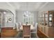 Elegant dining room with tray ceiling, chandelier, and large window at 848 Hawk Lndg, Fruitland Park, FL 34731
