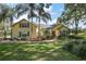 Charming yellow two-story home featuring mature landscaping, a welcoming walkway, and beautiful curb appeal at 848 Hawk Lndg, Fruitland Park, FL 34731
